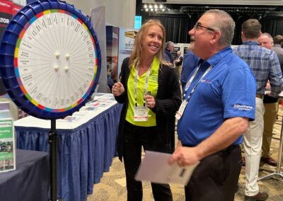 New Jersey AWWA Conference in Atlantic City 2023 - Two Conference Attendees Ready to Spin the Wheel